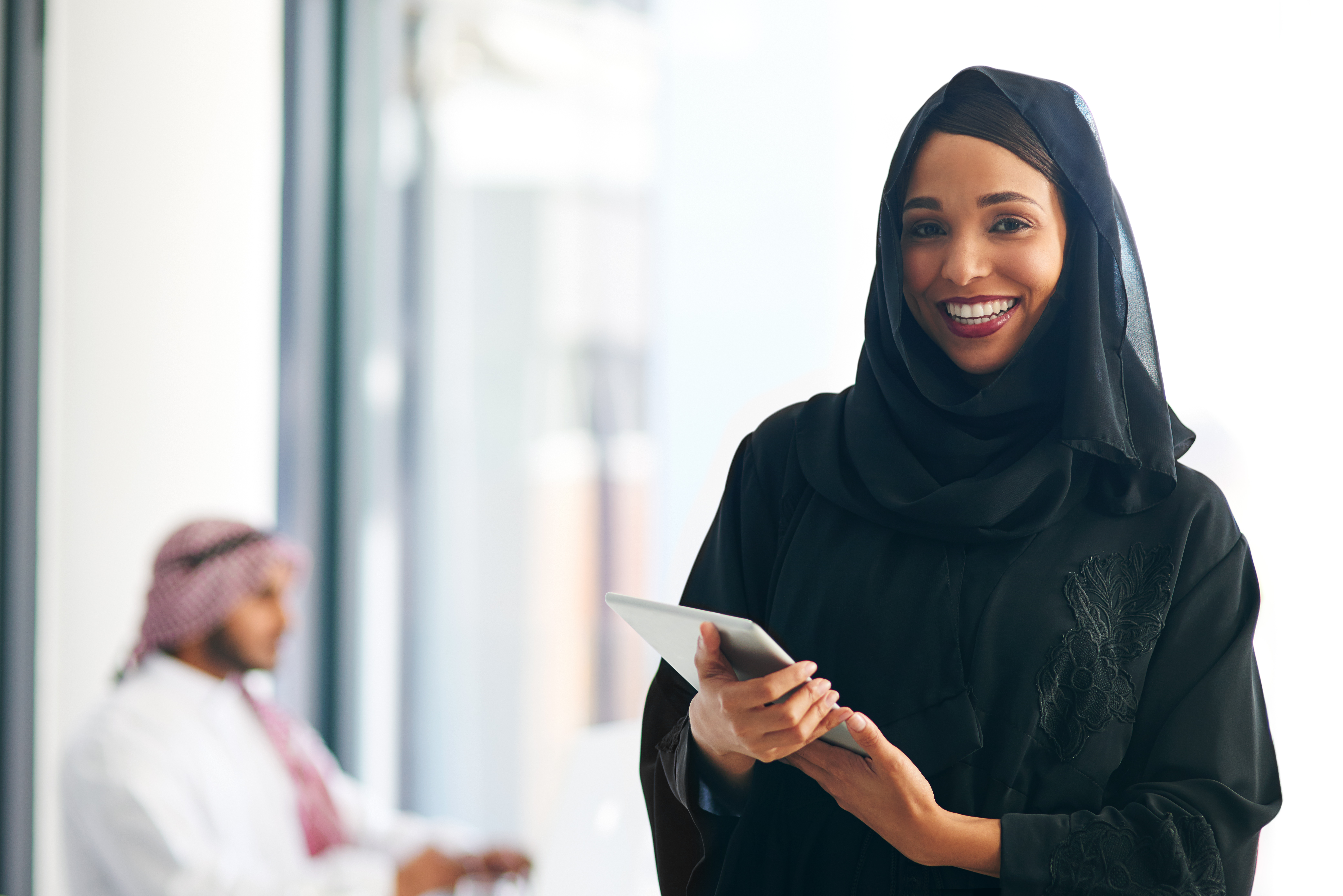 An emerging digital leader in a GCC workplace using a tablet