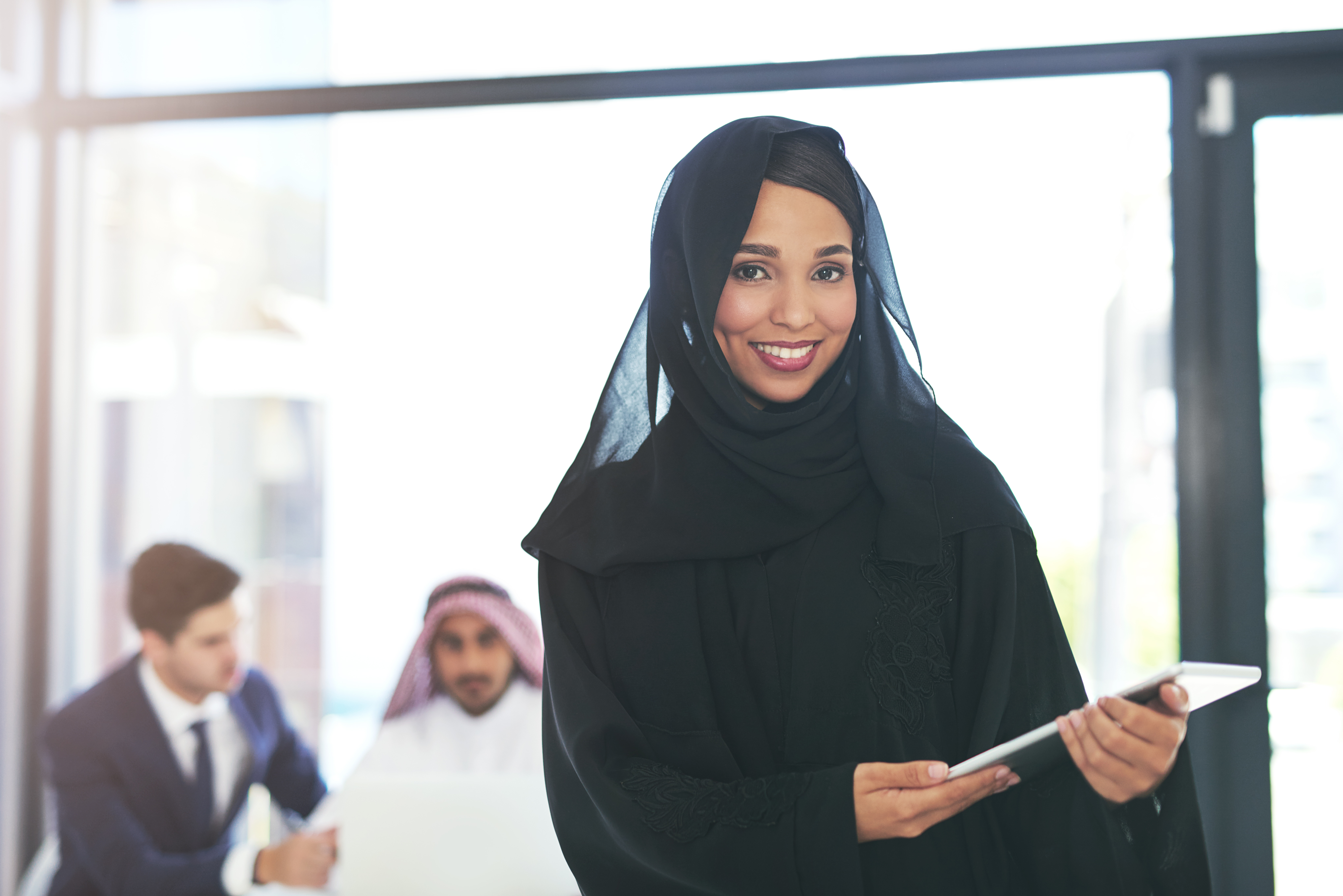 An ESPER client team collaborating in a modern Gulf office